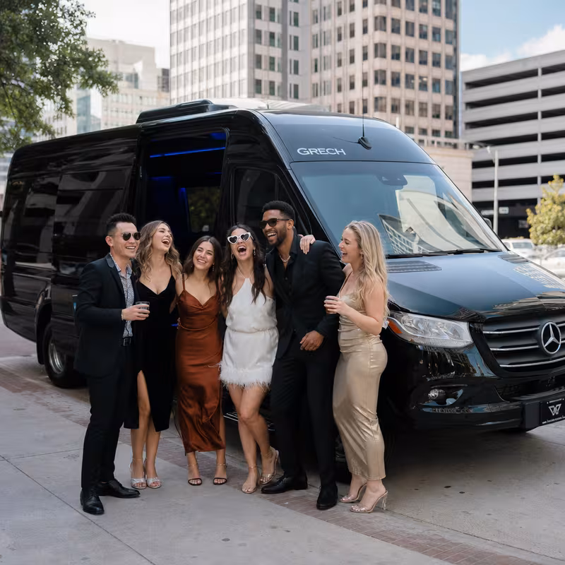 Group boarding a white charter bus for Bachelor & Bachelorette Transportation transportation in Birmingham