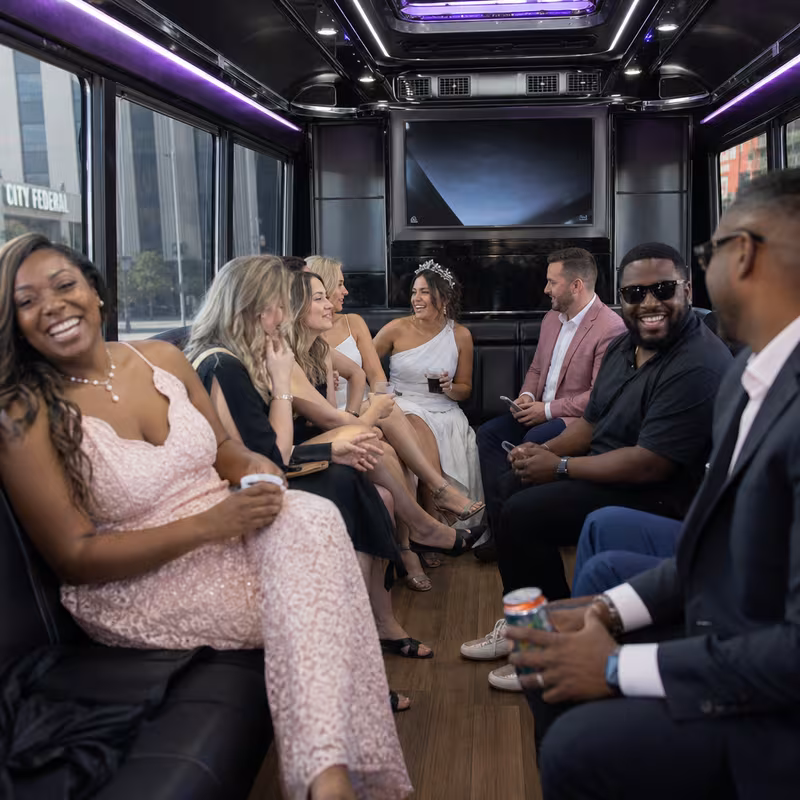 Party bus interior with wraparound leather seating and LED lighting in Birmingham