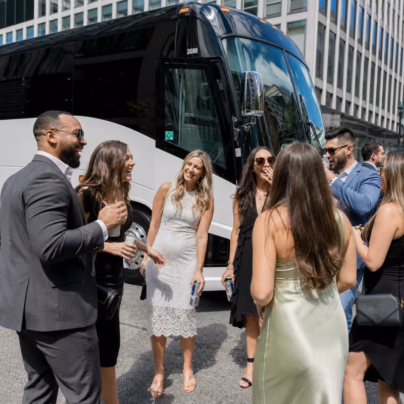 Passengers loading luggage while boarding an Birmingham group shuttle