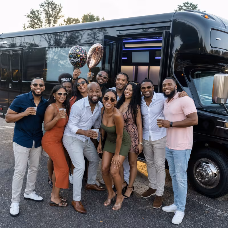 Group boarding a white charter bus for Birthday Transportation transportation in Birmingham