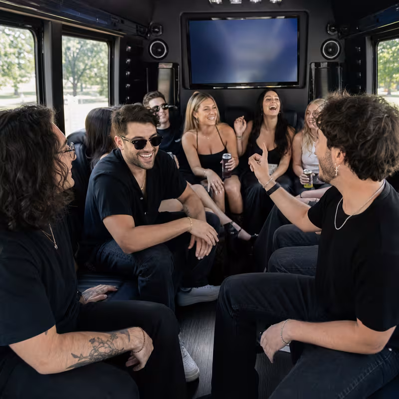 Group boarding a white charter bus for Concert Transportation transportation in Birmingham