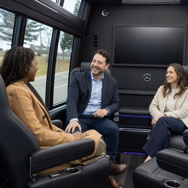 Group boarding a white charter bus for Corporate Transportation transportation in Birmingham