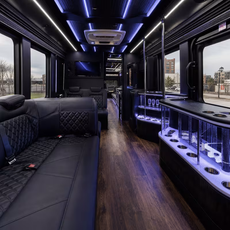 Party bus interior with wraparound leather seating and LED lighting in Birmingham