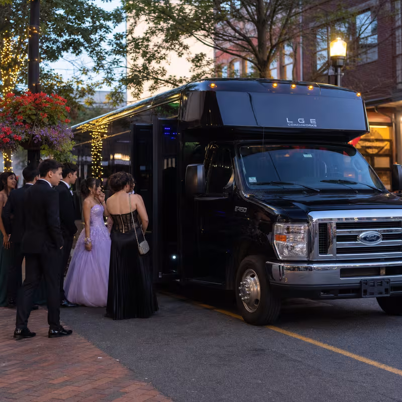 Passengers loading luggage while boarding an Birmingham group shuttle