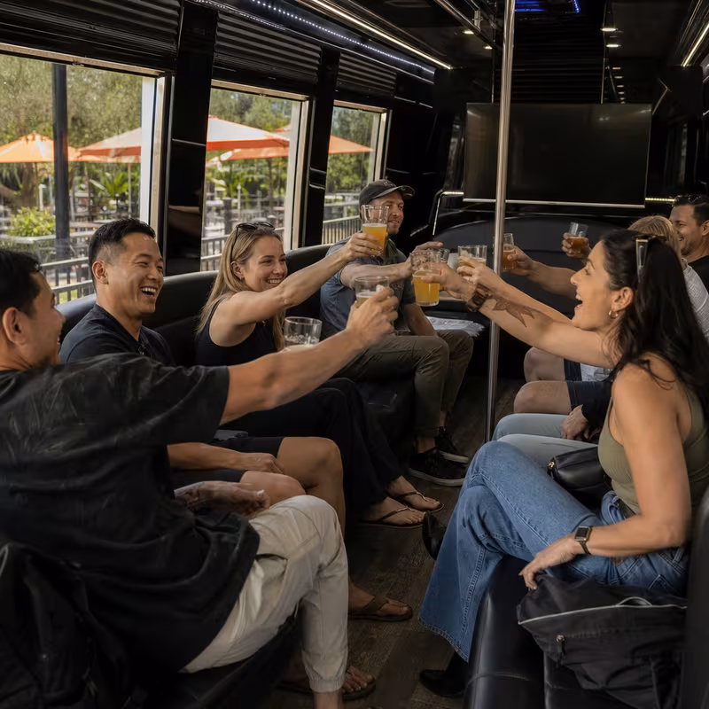 Group boarding a white charter bus for Winery & Brewery Tour Transportation transportation in Birmingham