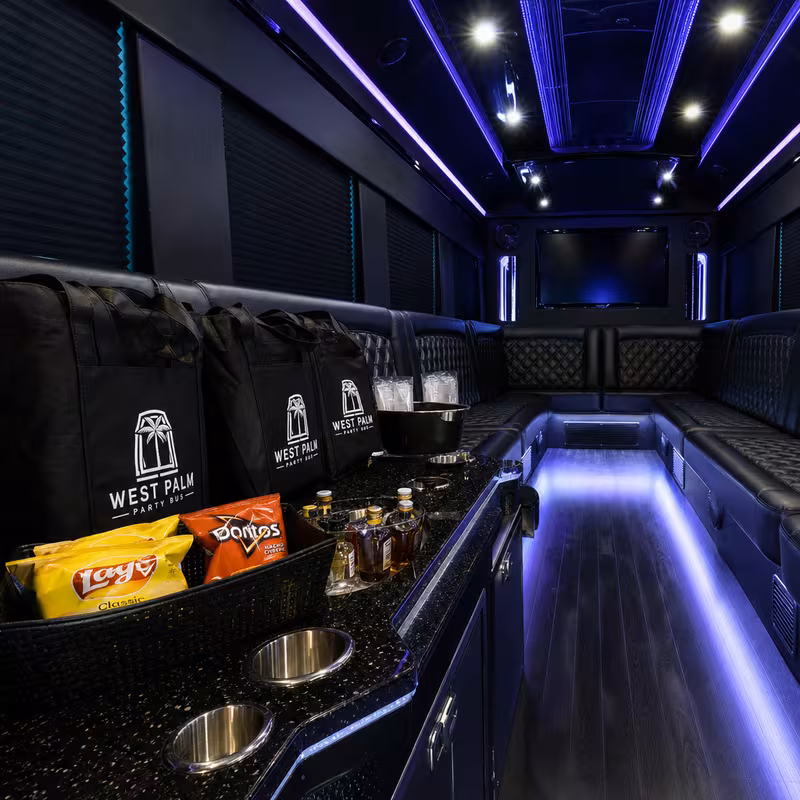Party bus interior with wraparound leather seating and LED lighting in Birmingham