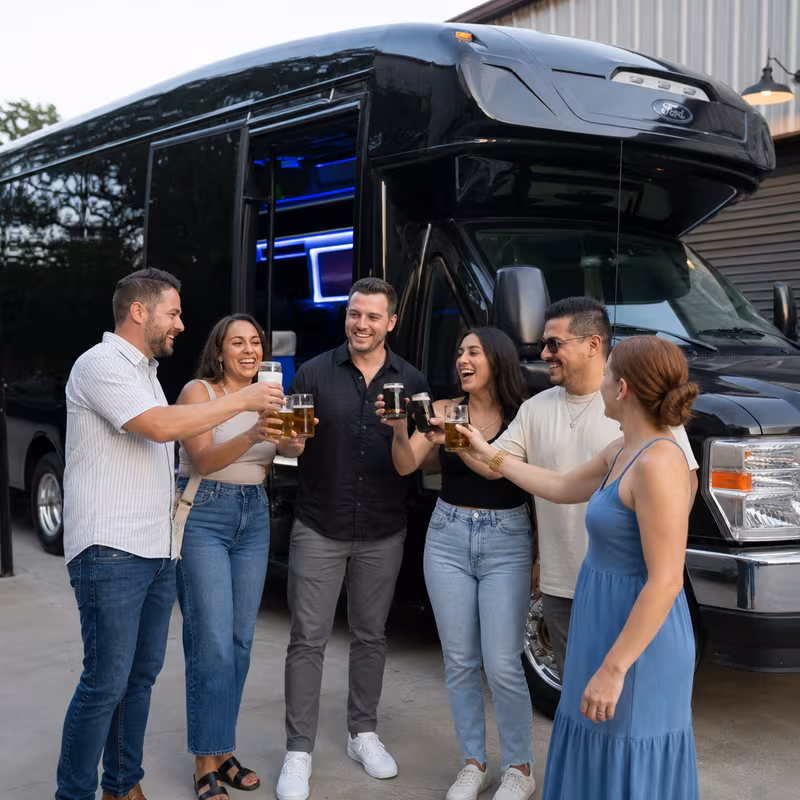 Passengers loading luggage while boarding an Birmingham group shuttle
